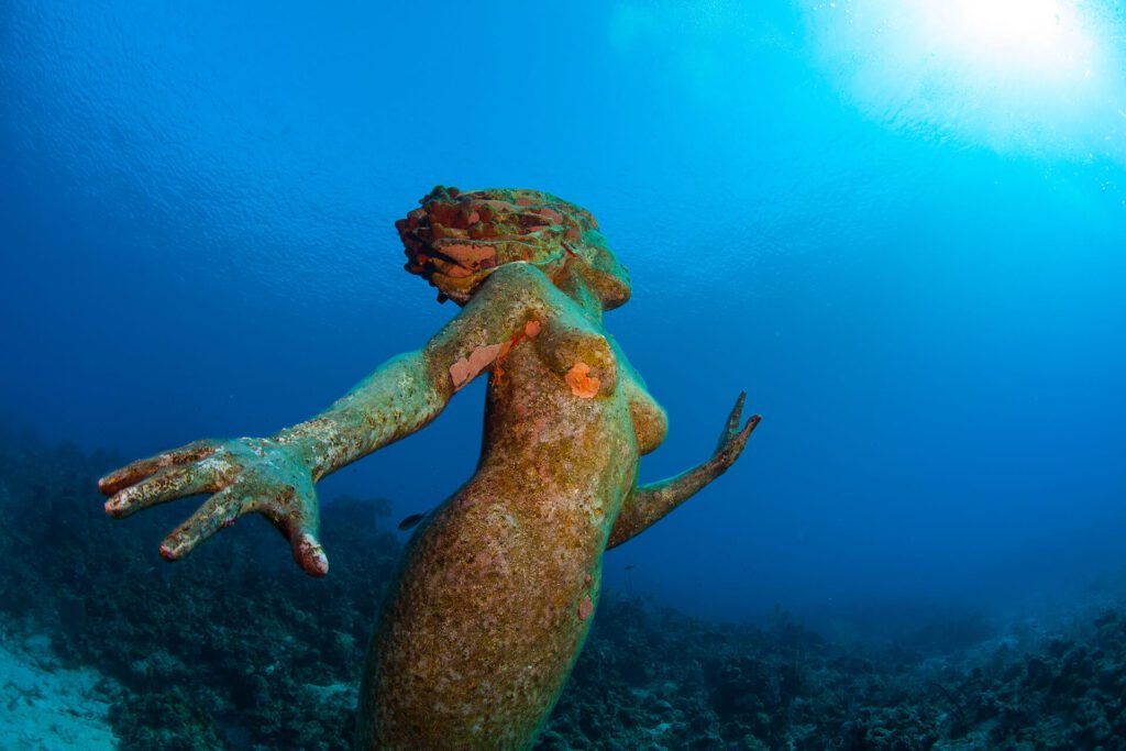 Mermaid statue under water